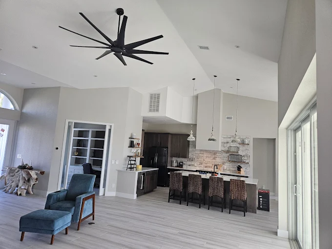 Luxurious open concept kitchen and living area renovation in Old Naples FL with 12-foot waterfall island
