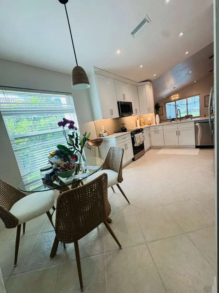 Luxury kitchen remodel in Pelican Bay Naples FL with custom white cabinetry and premium stone countertops