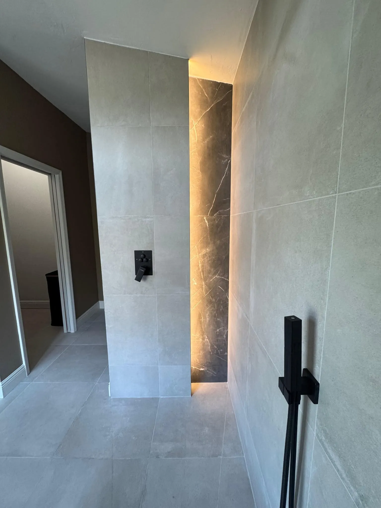 Modern industrial home renovation in Park Shore Naples FL featuring open glass walls and custom walnut cabinetry